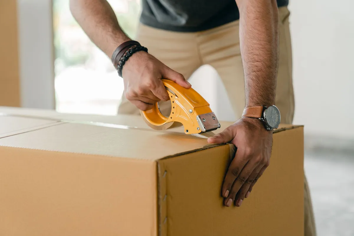 Carefully preparing a box for moving